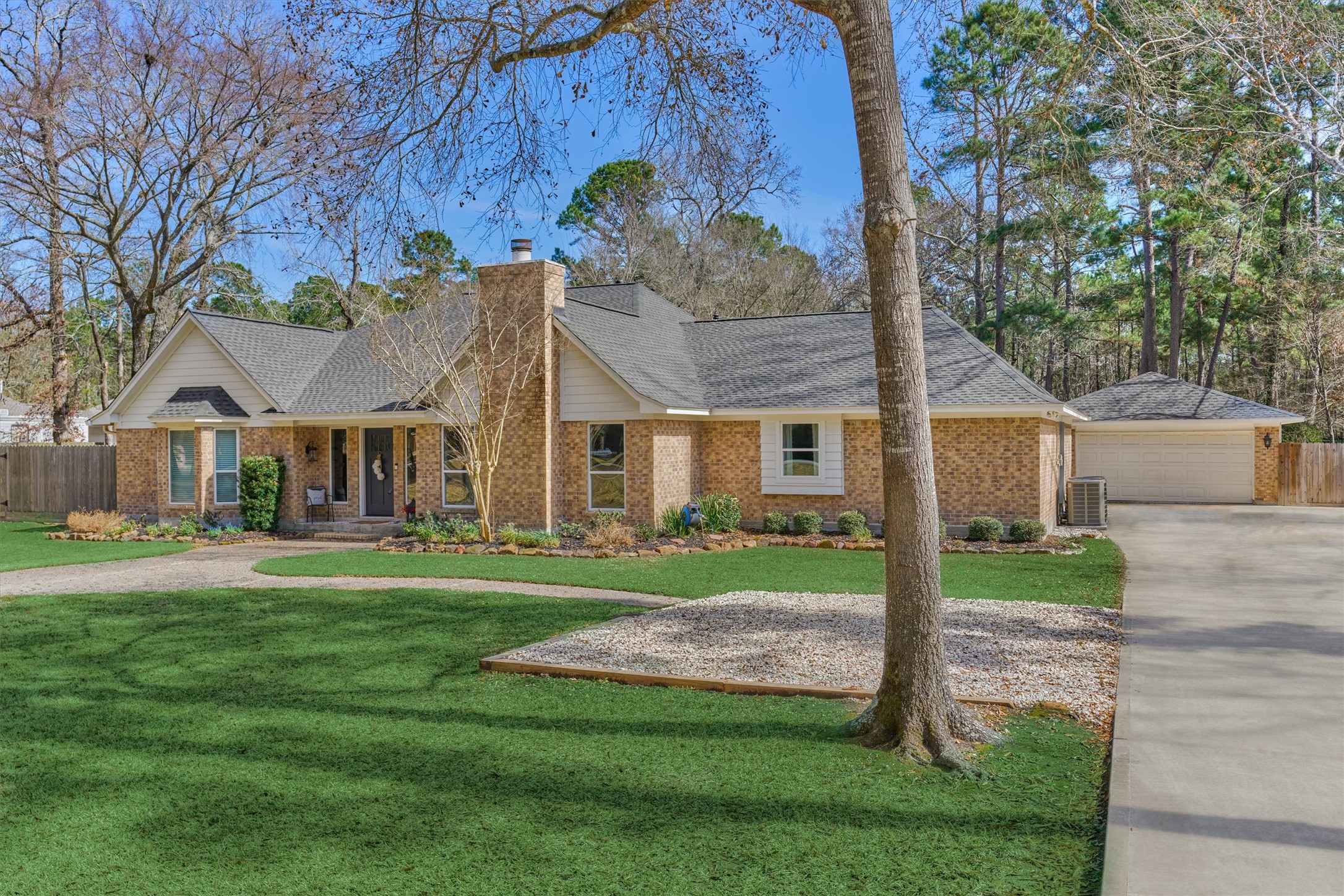 8 Wind River Court Conroe, TX 77384 - Photo 44 of 50 Bonus parking pad offers flexibility alongside new driveway and detached garage. This home is "circle driveway ready" should homeowners wish to make that addition.