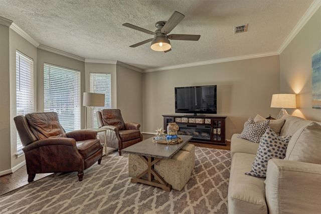 a kitchen with stainless steel appliances kitchen island granite countertop a refrigerator and a stove top oven