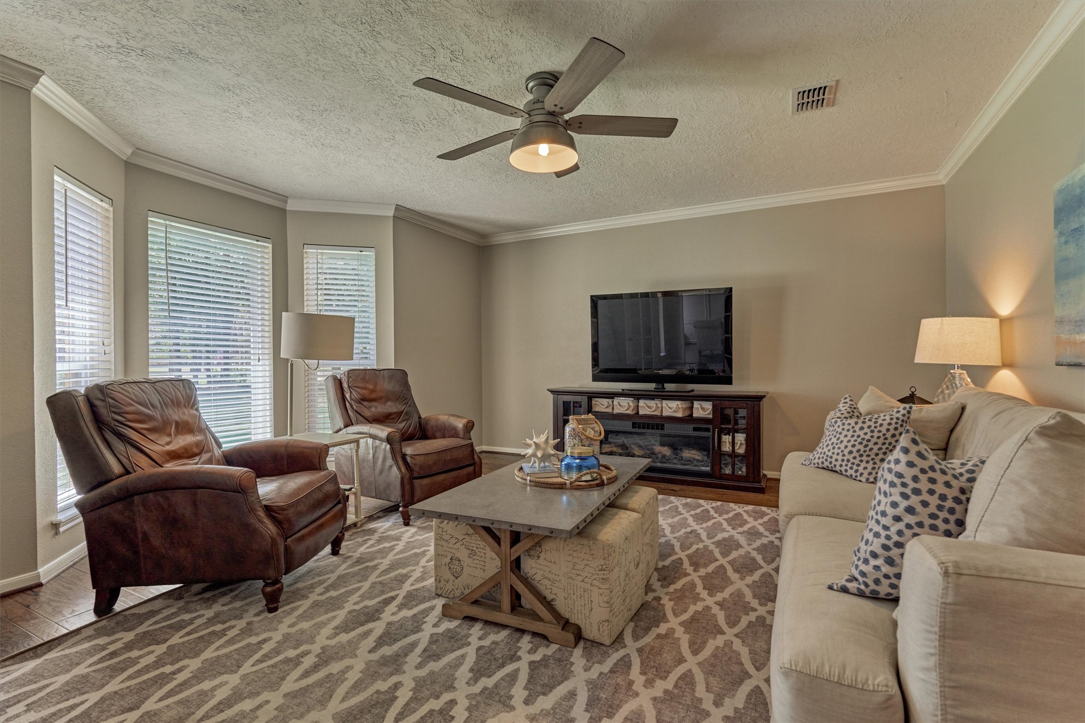 8 Wind River Court Conroe, TX 77384 - Photo 6 of 50 Complete with French doors for added privacy and true hardwood floors, this light and bright family room is ideally situated.