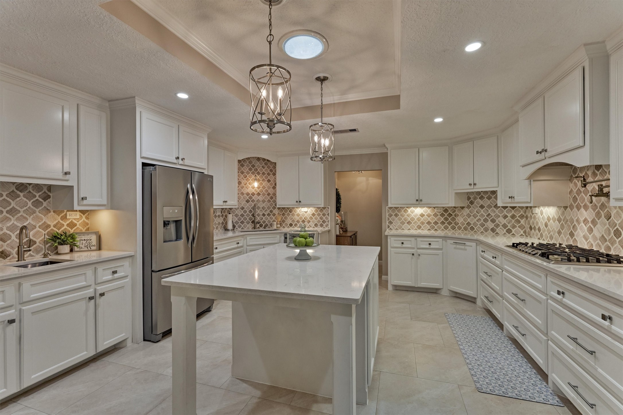 8 Wind River Court Conroe, TX 77384 - Photo 10 of 50 Freshly painted cabinets with decorative pulls and sleek pendant lighting complement this upgraded kitchen.