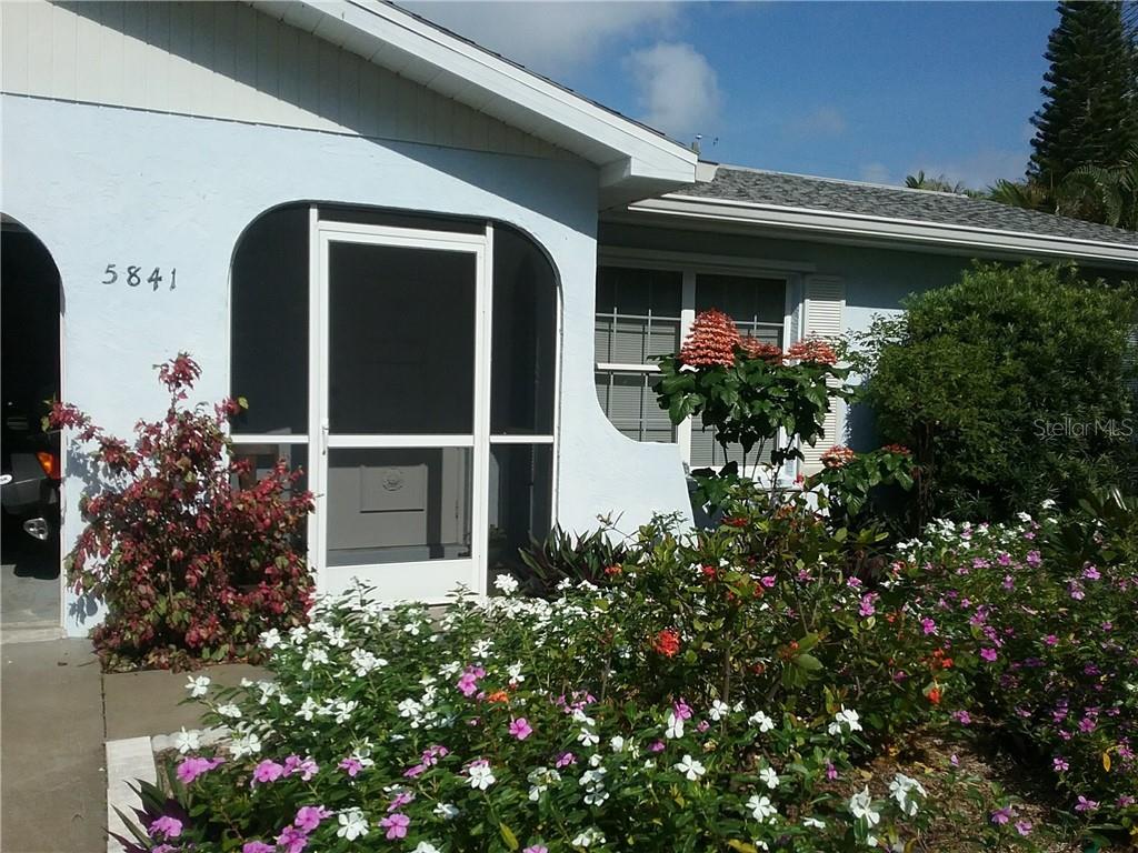5841 Marigold Road Venice, FL 34293 - Photo 1 of 1 a house with a flower garden in front of it