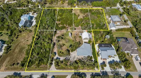 an aerial view of residential houses with outdoor space and street view
