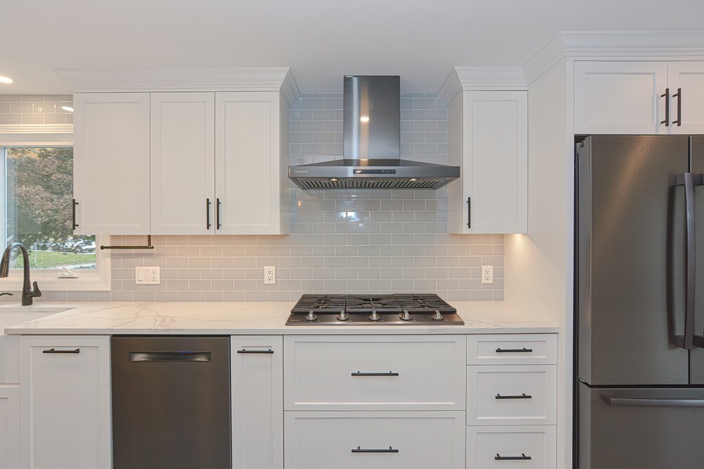 346 Highland Street Dedham, MA 02026 - Photo 11 of 42 a kitchen with a refrigerator and a stove