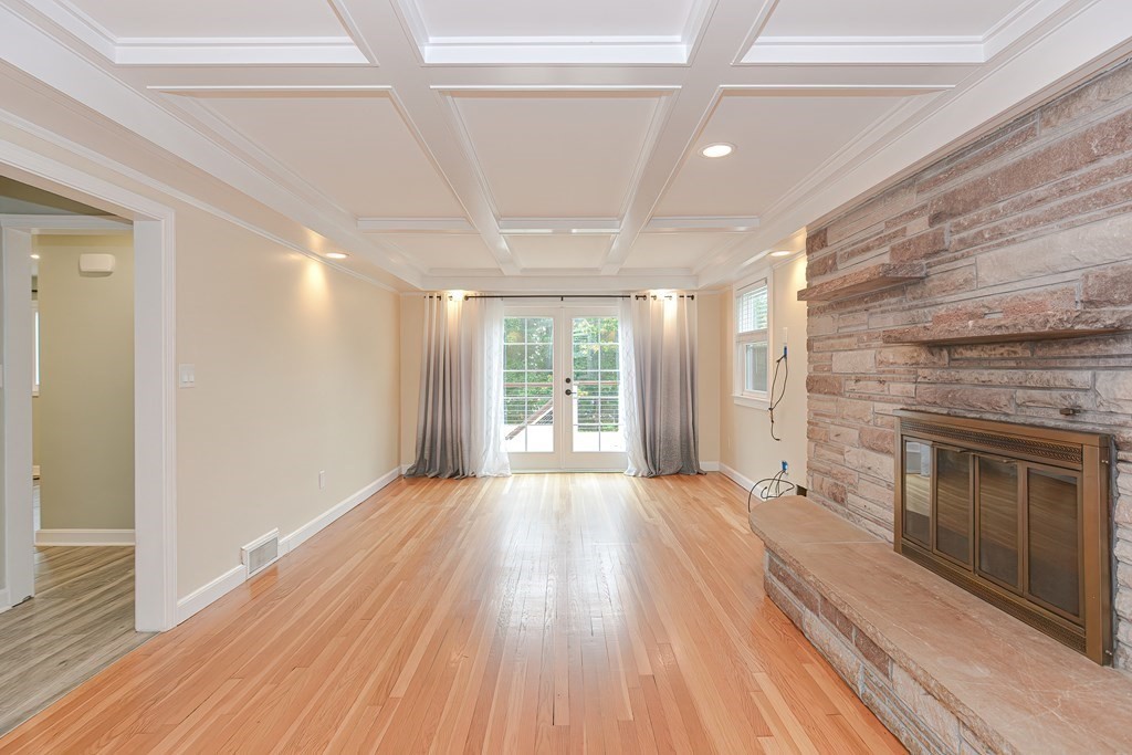 346 Highland Street Dedham, MA 02026 - Photo 16 of 42 a view of an empty room with wooden floor fireplace and a window