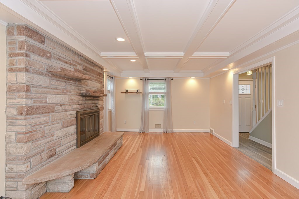 346 Highland Street Dedham, MA 02026 - Photo 17 of 42 a view of empty room with wooden floor and fireplace