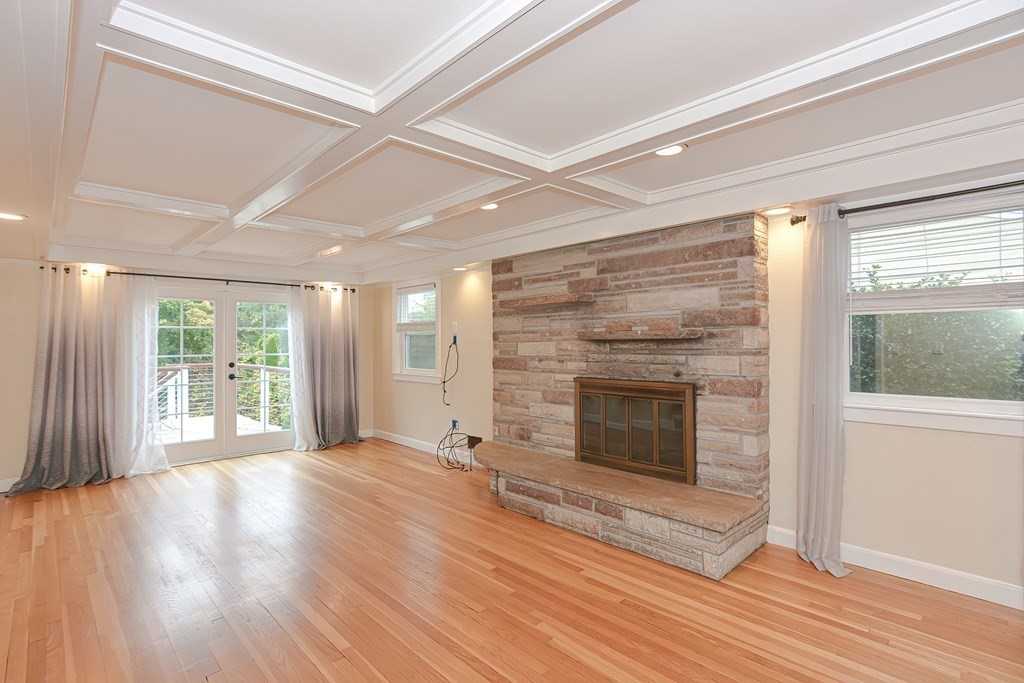 346 Highland Street Dedham, MA 02026 - Photo 18 of 42 a view of an empty room with wooden floor fireplace and a window