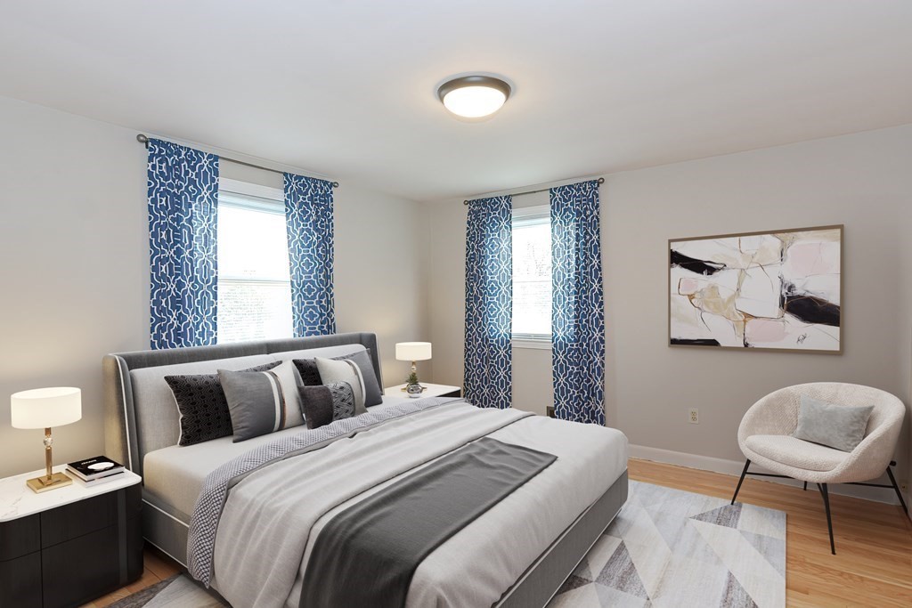 346 Highland Street Dedham, MA 02026 - Photo 21 of 42 a bedroom with a bed and painting on the wall