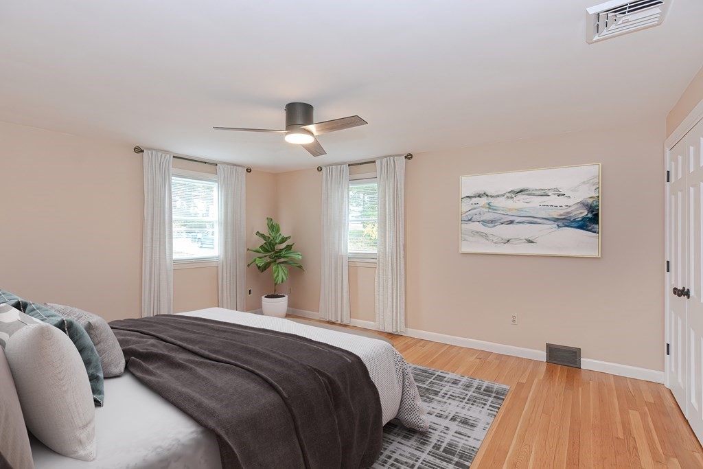 346 Highland Street Dedham, MA 02026 - Photo 22 of 42 a bedroom with a large bed and a chandelier