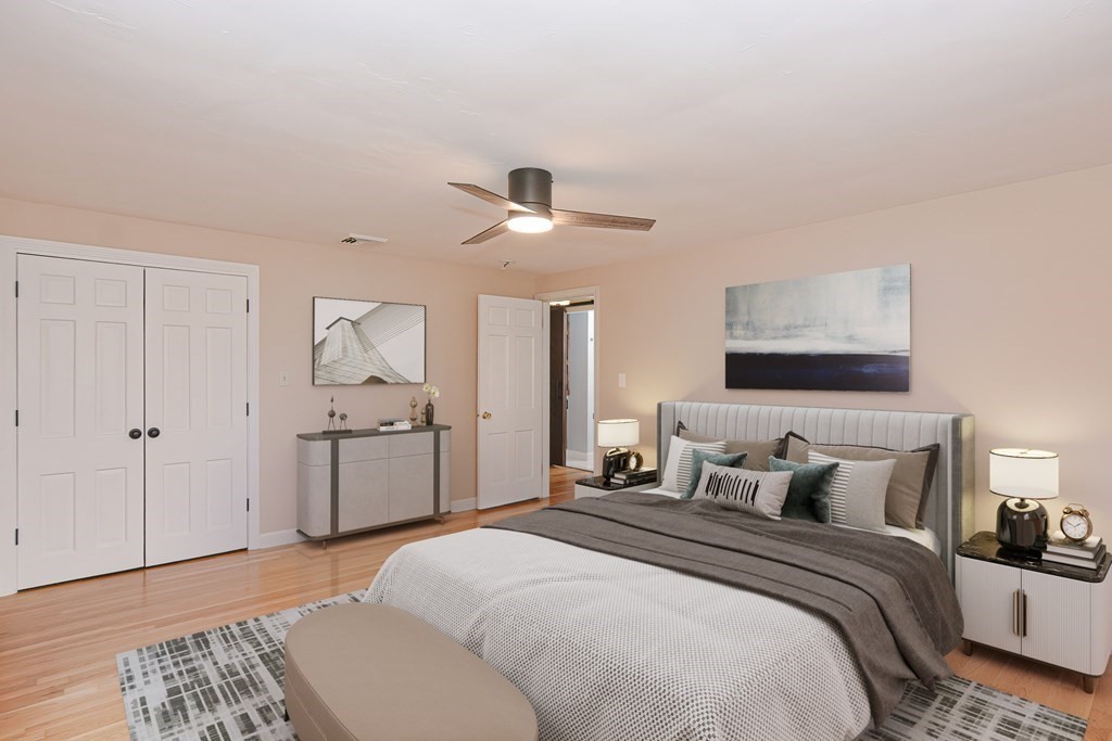 346 Highland Street Dedham, MA 02026 - Photo 24 of 42 a bedroom with a bed and a chandelier