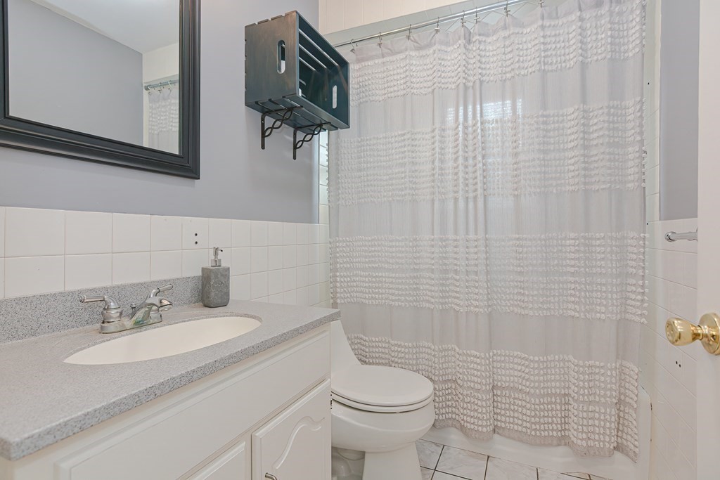 346 Highland Street Dedham, MA 02026 - Photo 25 of 42 a bathroom with a sink toilet and shower