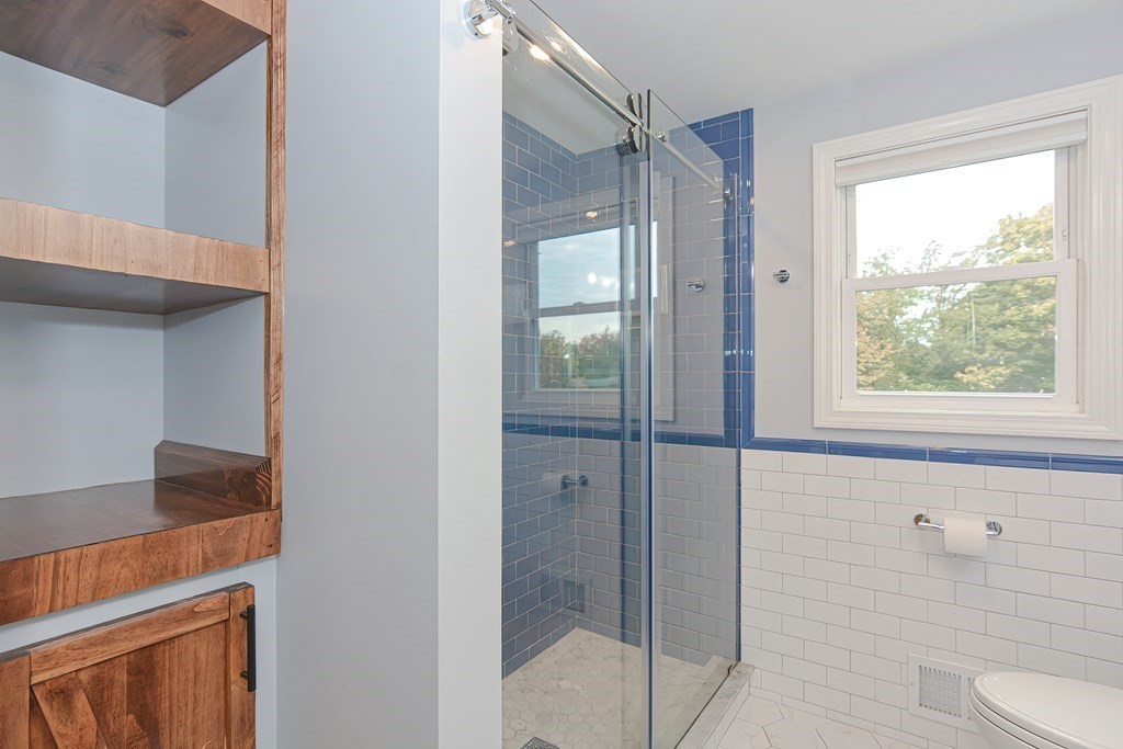346 Highland Street Dedham, MA 02026 - Photo 27 of 42 a bathroom with a shower and a toilet