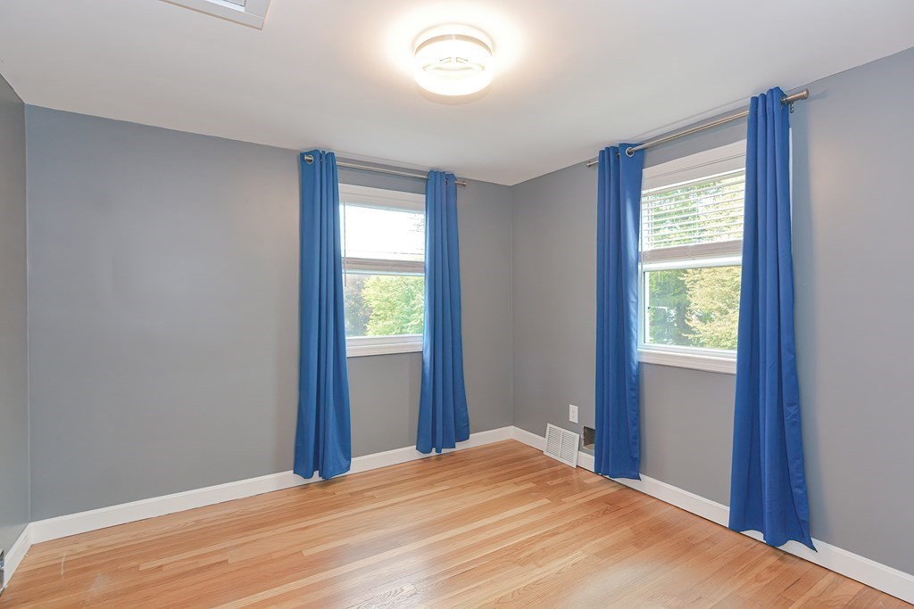 346 Highland Street Dedham, MA 02026 - Photo 30 of 42 a bedroom with a bed and a window