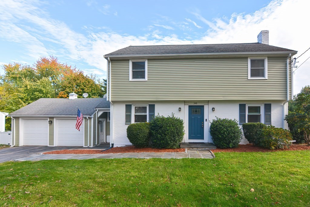 346 Highland Street Dedham, MA 02026 - Photo 3 of 42 a front view of a house with a garden and plants