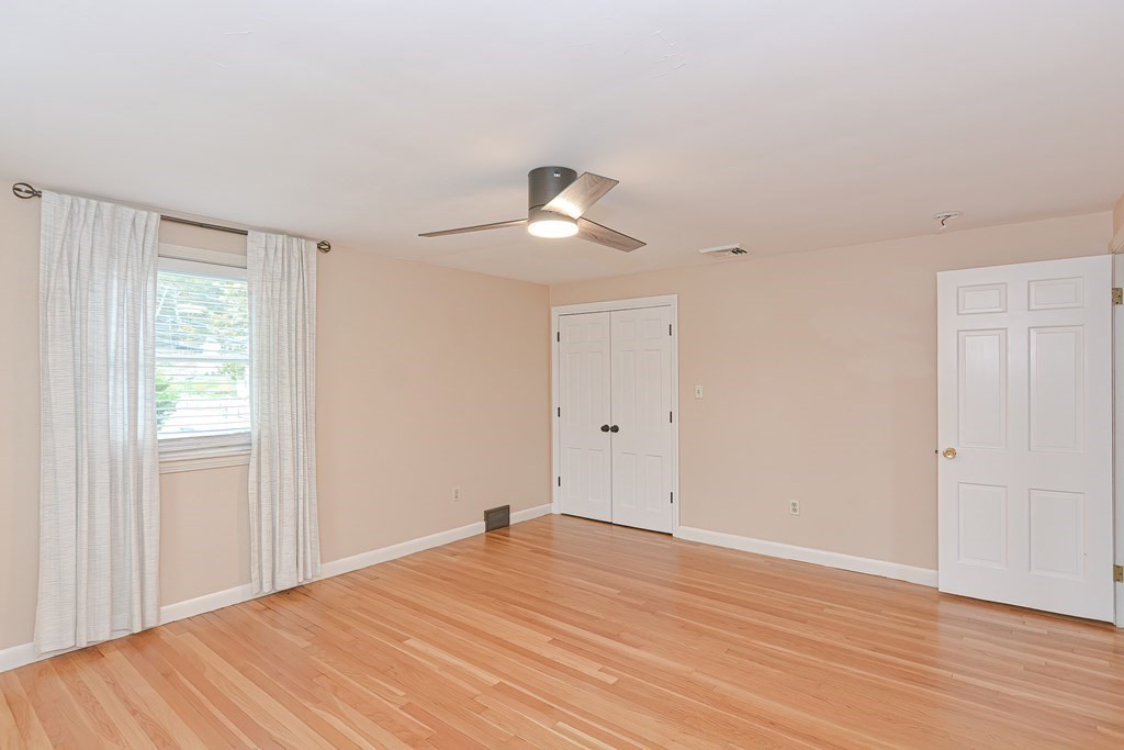 346 Highland Street Dedham, MA 02026 - Photo 31 of 42 a view of empty room with wooden floor and fan