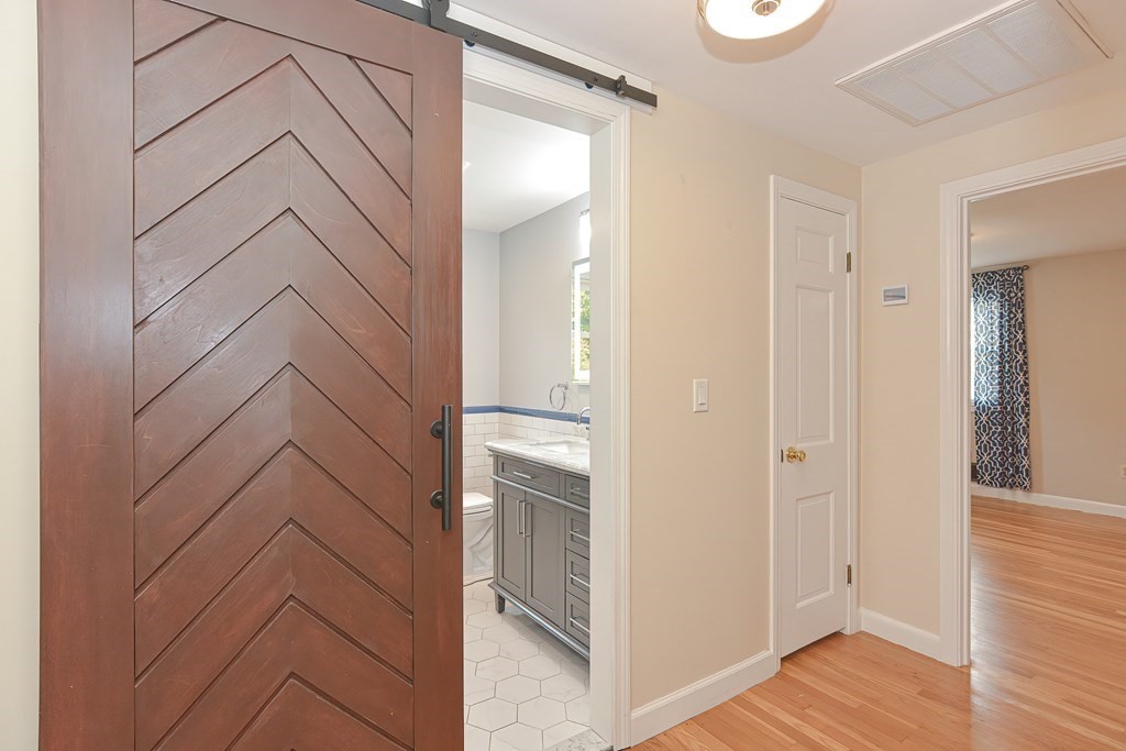 346 Highland Street Dedham, MA 02026 - Photo 34 of 42 a view of a bathroom with closet and mirror
