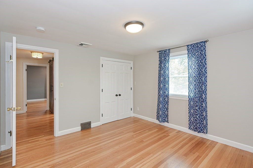 346 Highland Street Dedham, MA 02026 - Photo 35 of 42 a view of an empty room with wooden floor and a window