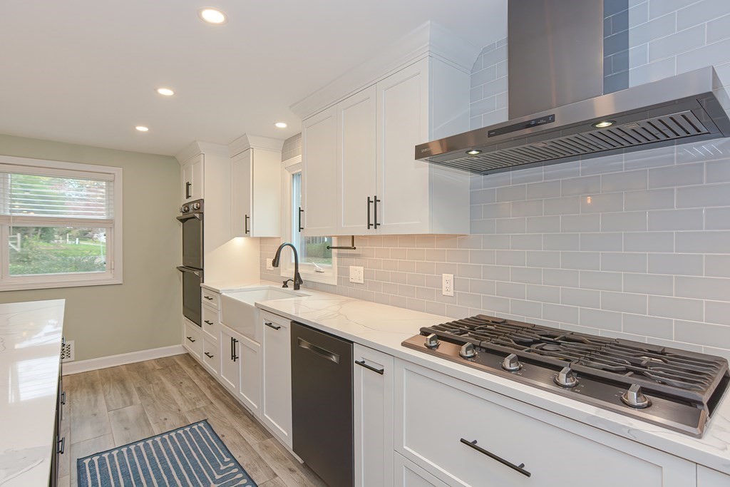 346 Highland Street Dedham, MA 02026 - Photo 10 of 42 a kitchen with a sink stove and cabinets