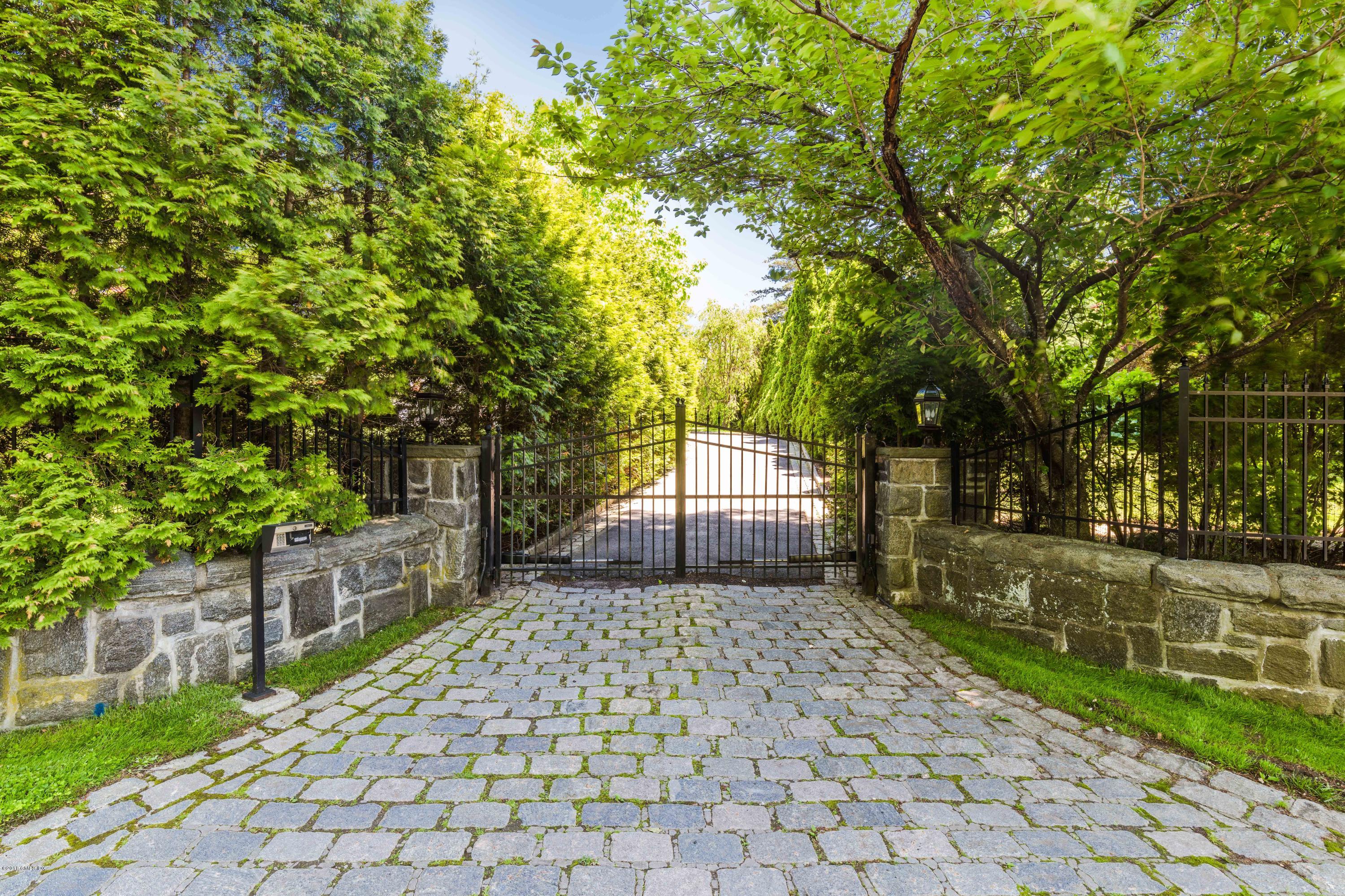 Undisclosed Address Greenwich, CT 06830 - Photo 1 of 1 a front view of a house with a patio