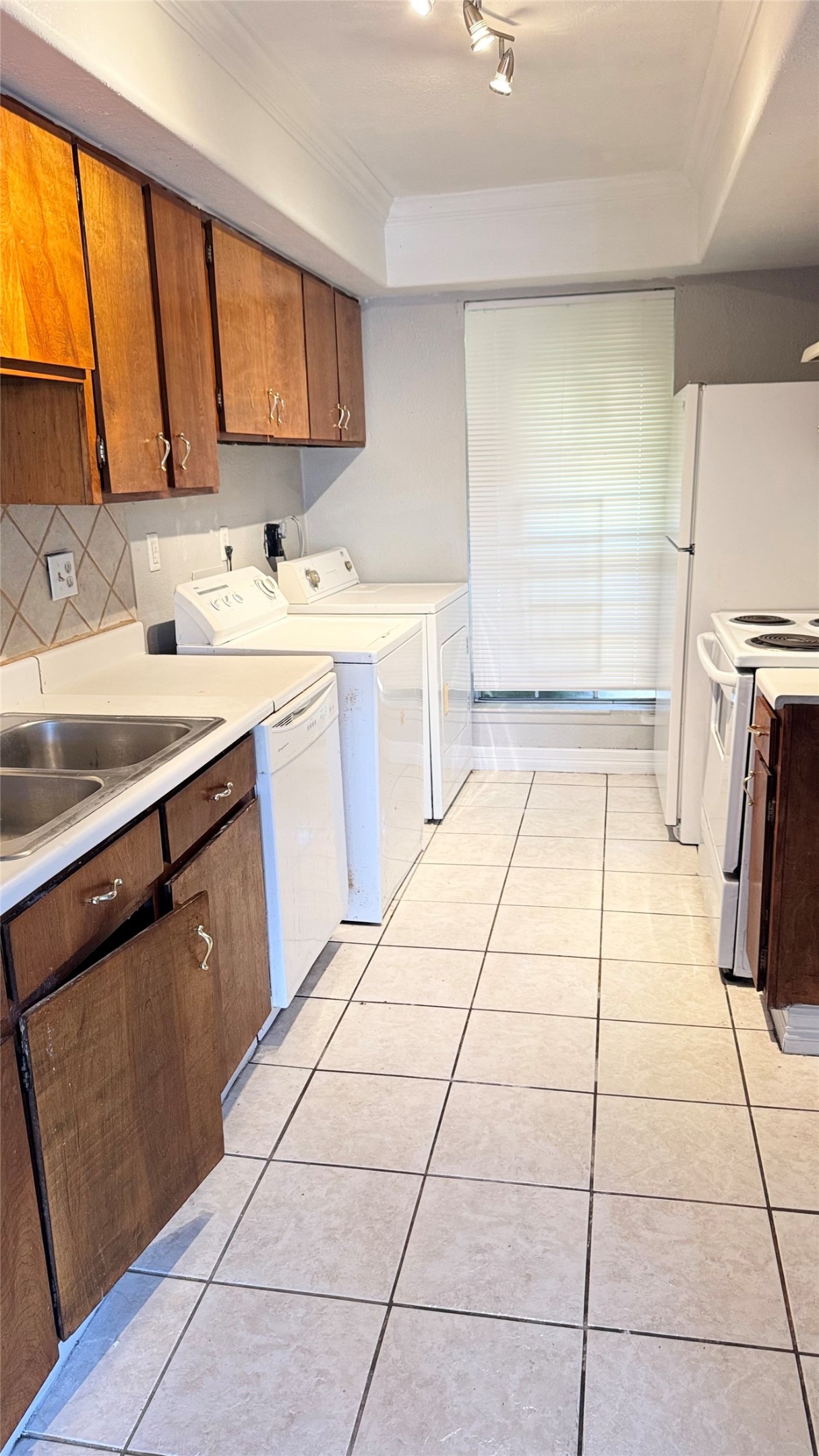 7818 Grove Ridge Drive Houston, TX 77061 - Photo 4 of 7 a kitchen with a sink a stove and a refrigerator