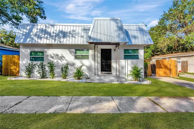 a front view of a house with a garden and yard