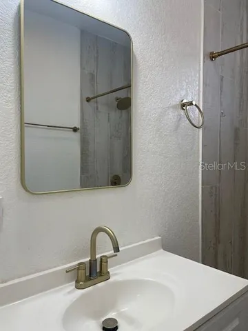a bathroom with a sink and mirror