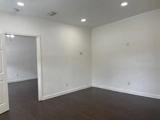 an empty room with wooden floor