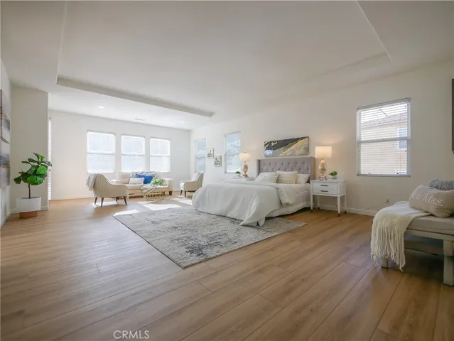 a bedroom with furniture and a wooden floor