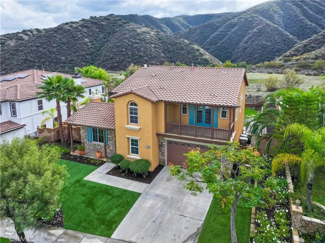 a aerial view of a house with a yard and plants