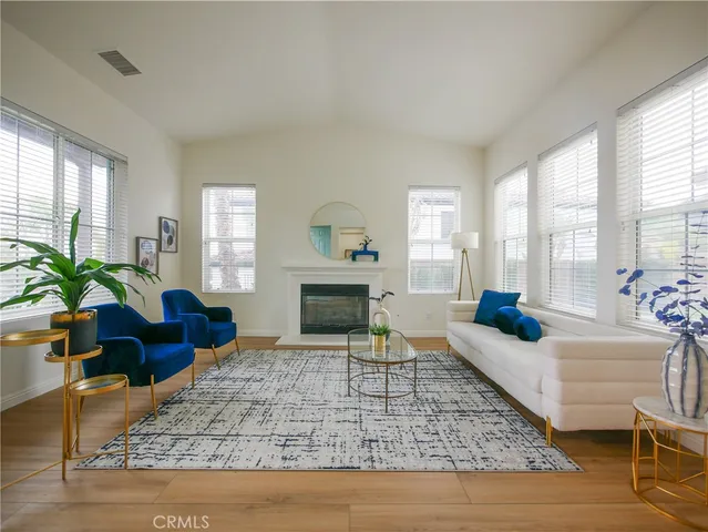 a living room with furniture and a fireplace