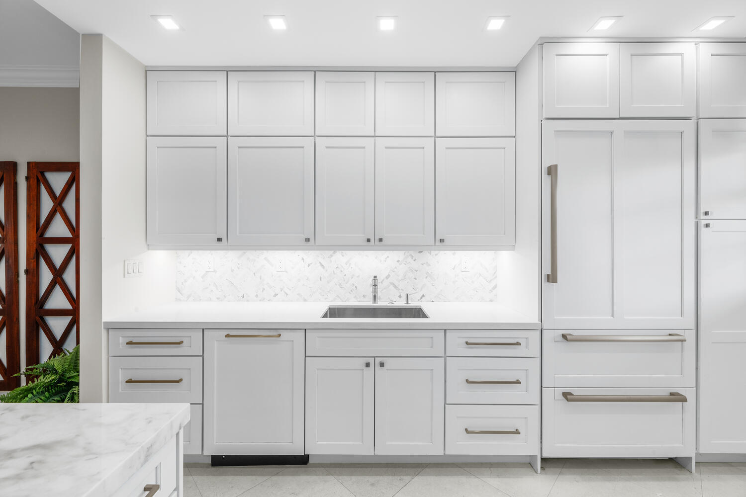 127 Peruvian Avenue, Unit 302 Palm Beach, FL 33480 - Photo 12 of 43 a kitchen with white cabinets and sink