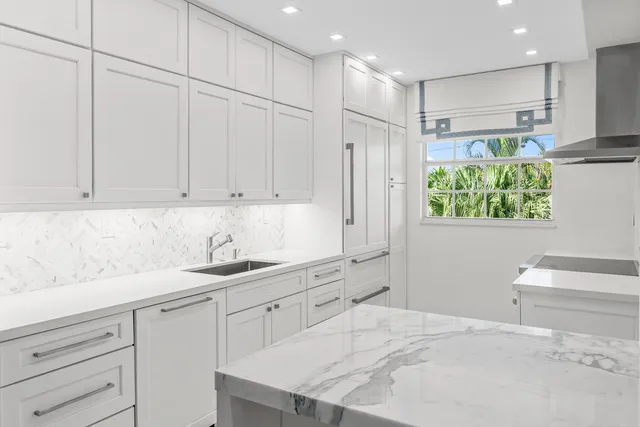 a kitchen with a sink window and cabinets