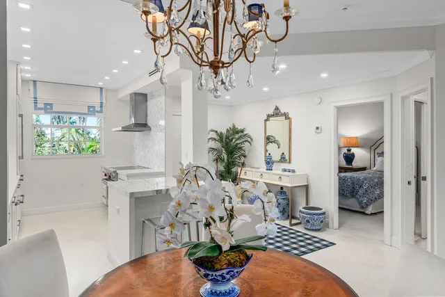 a living room with furniture a chandelier and a rug