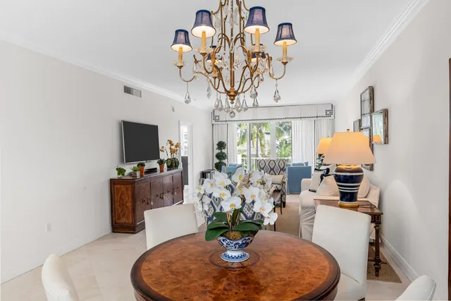 a dining room with furniture a chandelier and window