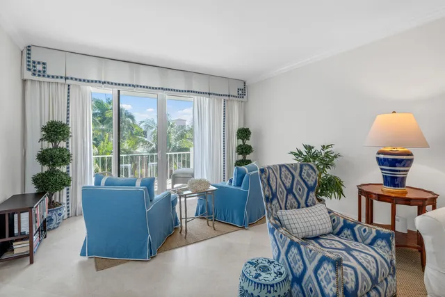 a view of a livingroom with furniture a rug and a potted plant