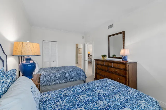 a bedroom with two bed and a dresser