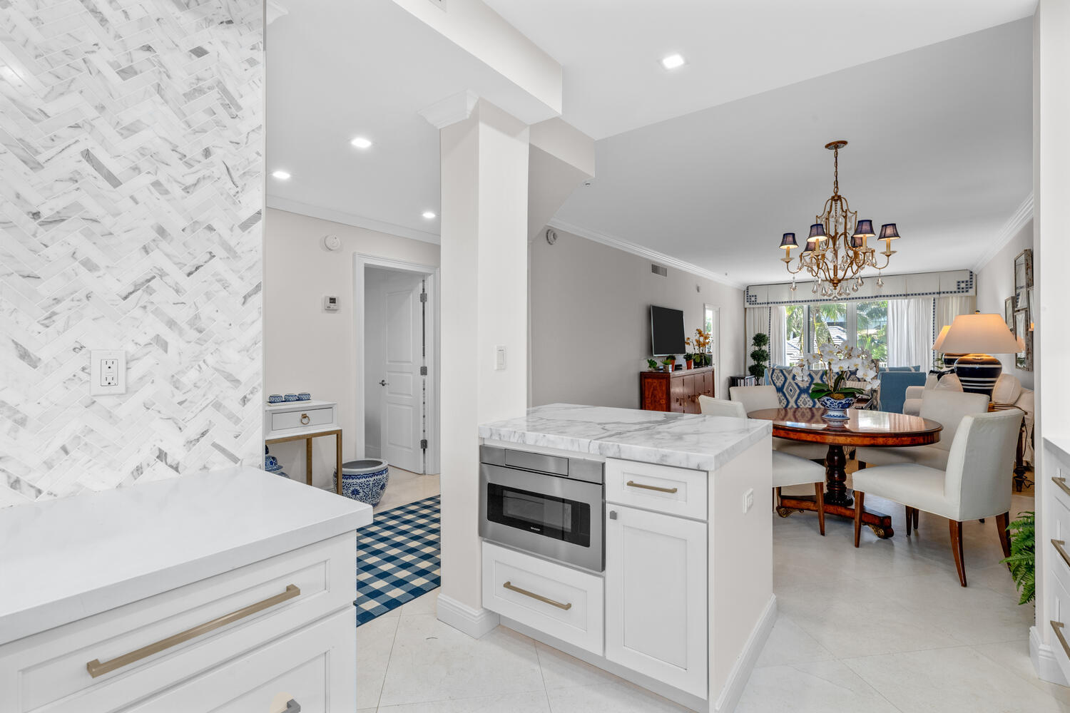 127 Peruvian Avenue, Unit 302 Palm Beach, FL 33480 - Photo 9 of 43 a kitchen with a white cabinets and chairs
