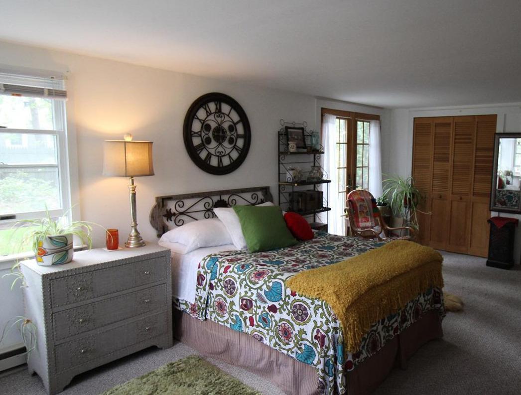 37 Bartlett Road Wellfleet, MA 02667 - Photo 5 of 14 a bedroom with a bed and a lamp on dresser next to a window
