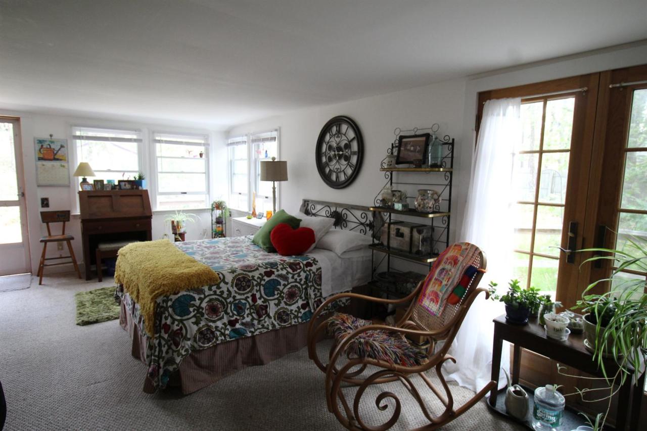 37 Bartlett Road Wellfleet, MA 02667 - Photo 6 of 14 a living room with furniture a window and a clock