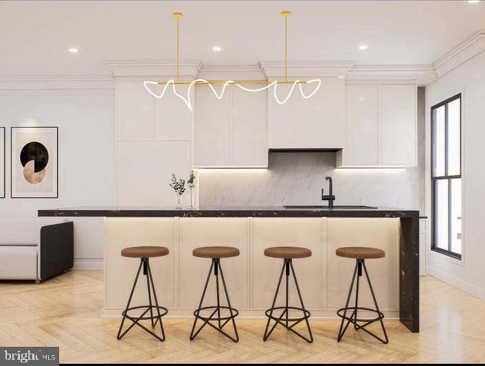 a kitchen with stainless steel appliances a table chairs in it and wooden floors