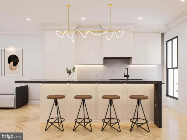 a kitchen with stainless steel appliances a table chairs in it and wooden floors