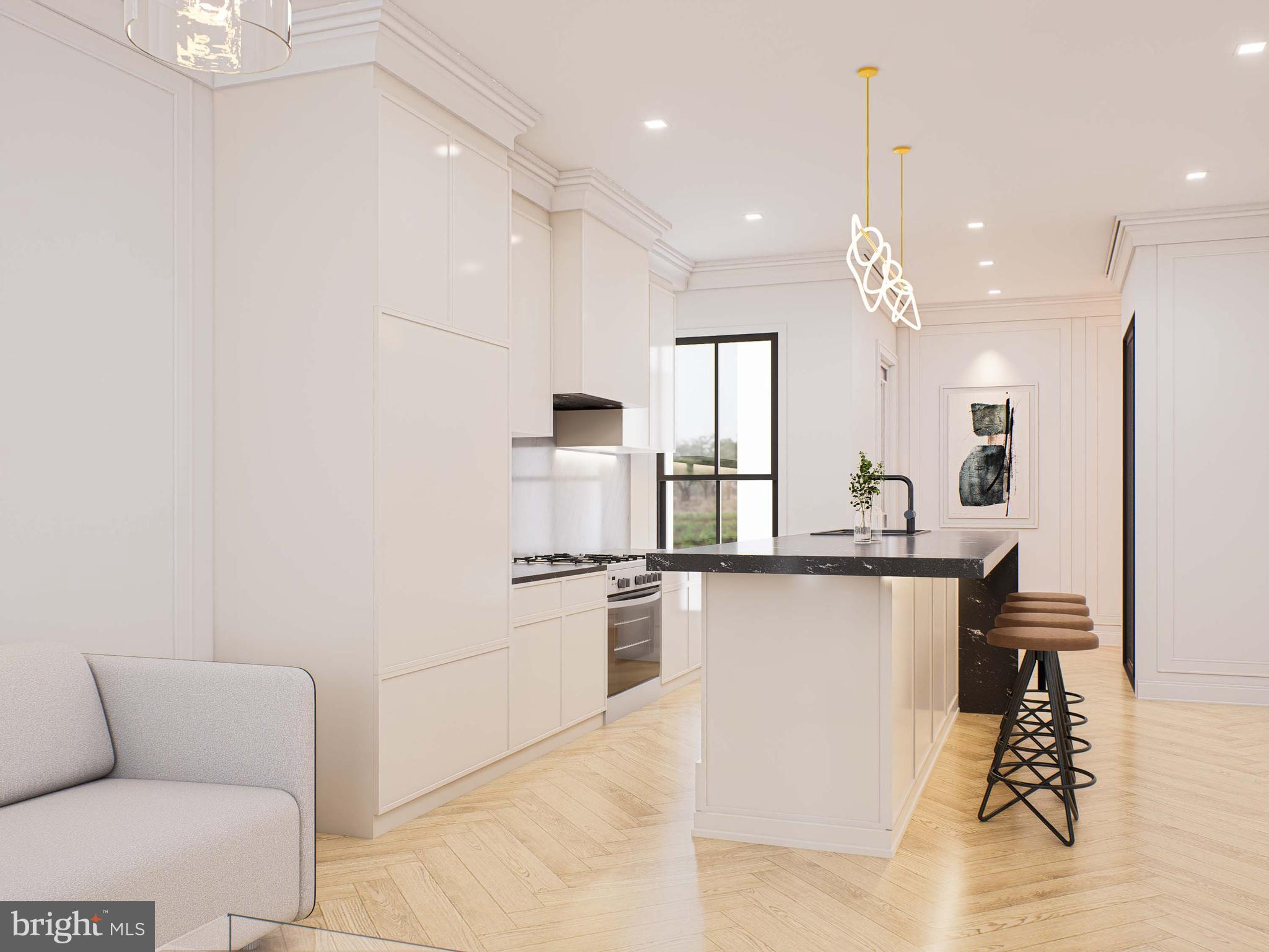 1415 Q Street Northwest, Unit 2 Washington, DC 20009 - Photo 2 of 6 a kitchen with stainless steel appliances kitchen island hardwood floor sink and stove