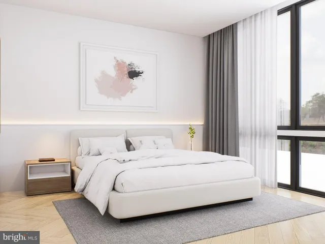 a bedroom with a bed and a painting on the wall