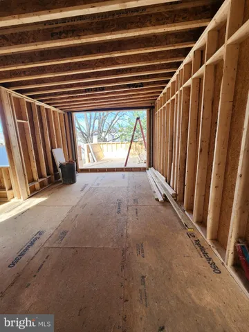 a view of an empty room with a fireplace and a window