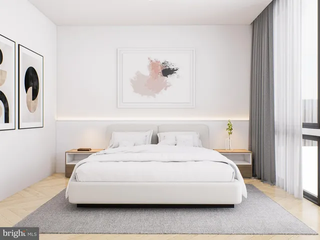 a bedroom with a bed and a painting on the wall