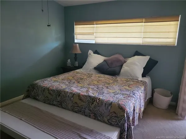 a bedroom with a bed and window