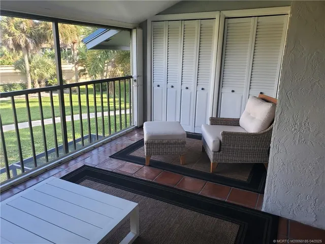 a living room with large window and furniture