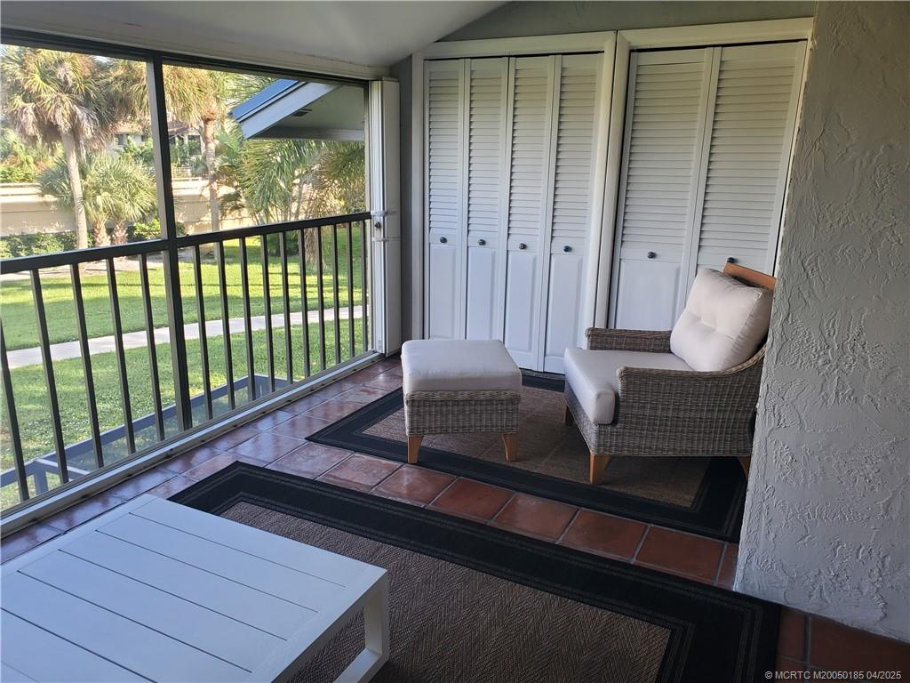 1411 Northeast 14th Court, Unit 13 Jensen Beach, FL 34957 - Photo 18 of 20 a living room with large window and furniture