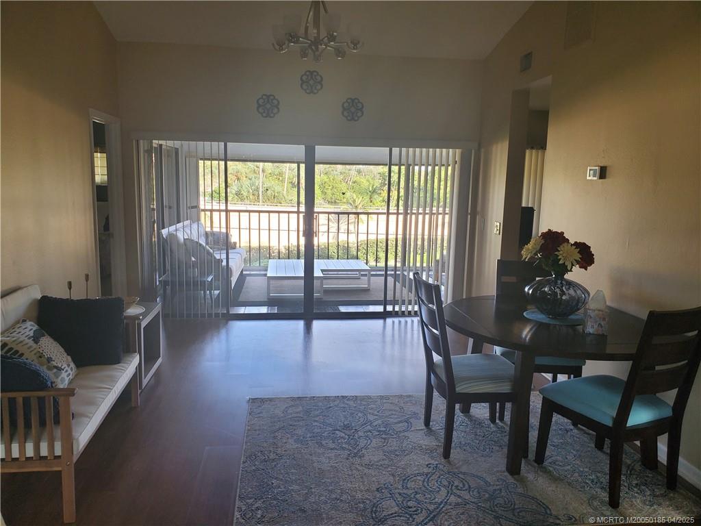 1411 Northeast 14th Court, Unit 13 Jensen Beach, FL 34957 - Photo 8 of 20 a living room with furniture and a large window