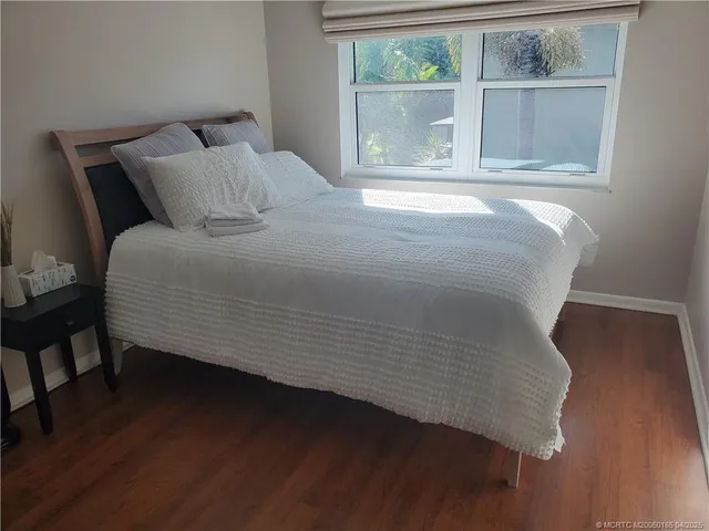 a bed sitting in a bedroom next to a window