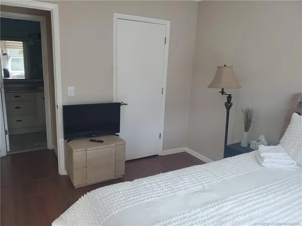 a bedroom with a bed and a flat screen tv